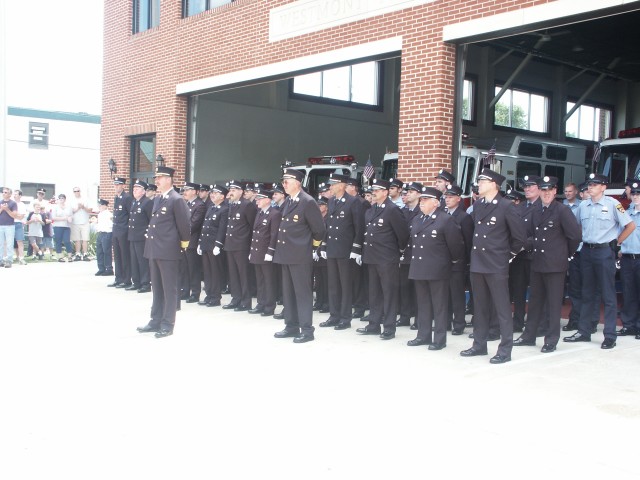 Members of the Westmont Fire Company watch the parade as other fire companies pass by the firehouse.